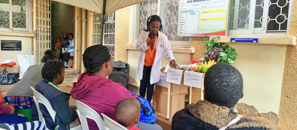 nutritionist teaching on body building foods at kamwokya Christian caring community